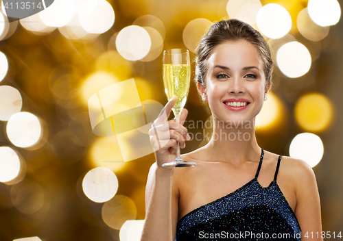 Image of smiling woman holding glass of champagne