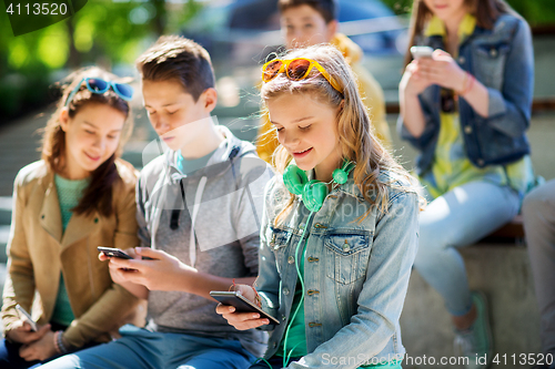 Image of happy teenage girl with smartphone and headphones