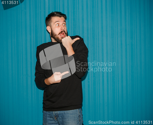 Image of Portrait of young man with shocked facial expression