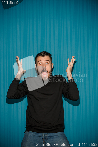 Image of Portrait of young man with shocked facial expression