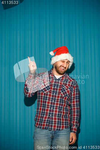 Image of Smiling christmas man wearing a santa hat