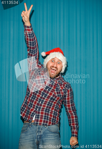 Image of Smiling christmas man wearing a santa hat