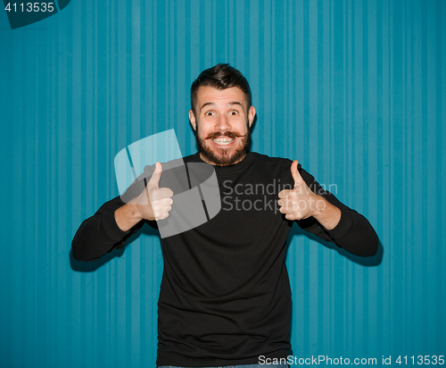 Image of The young happy man looking at camera