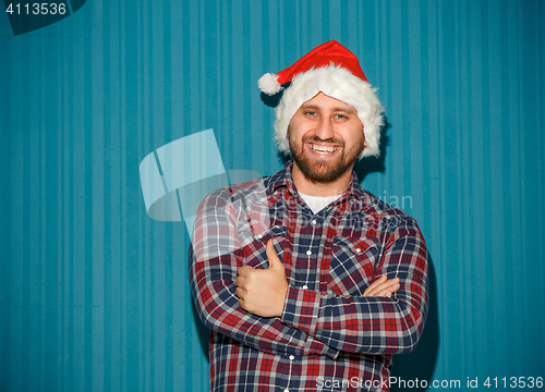Image of Smiling christmas man wearing a santa hat