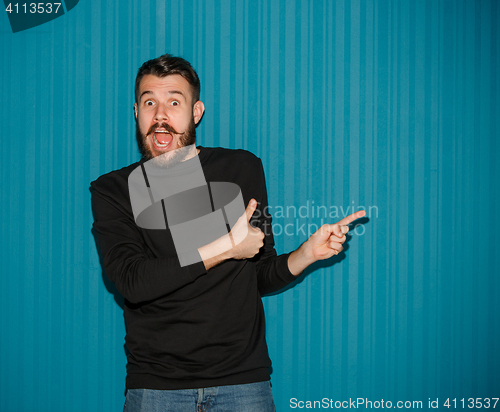 Image of Portrait of young man with shocked facial expression