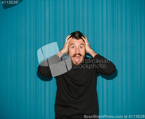 Image of Portrait of young man with shocked facial expression