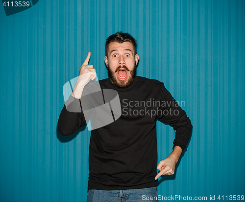 Image of Portrait of young man with shocked facial expression