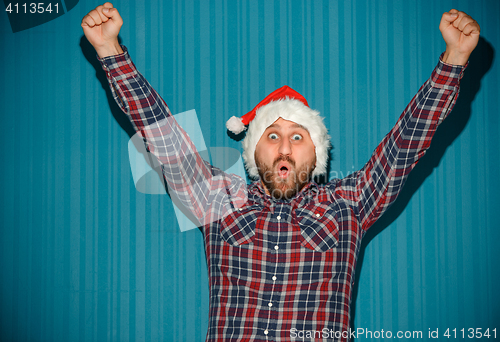 Image of Smiling christmas man wearing a santa hat