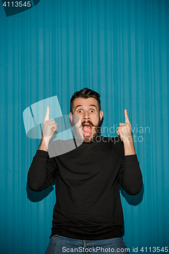 Image of Portrait of young man with shocked facial expression