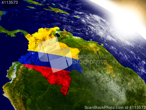 Image of Colombia with flag in rising sun