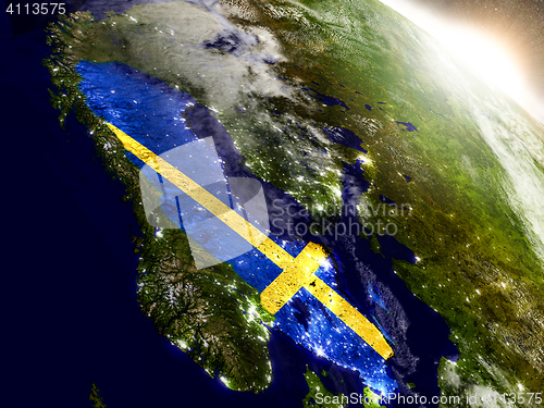 Image of Sweden with flag in rising sun