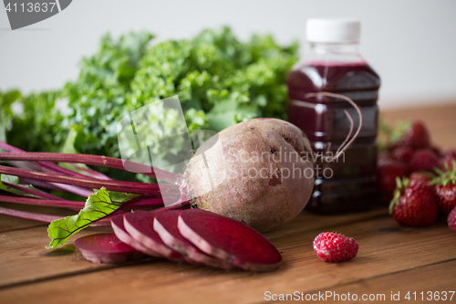 Image of bottle with beetroot juice, fruits and vegetables