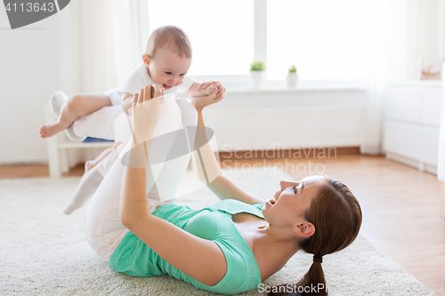 Image of happy mother playing with baby at home