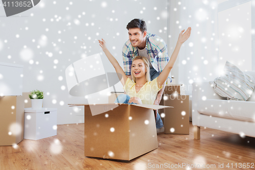 Image of happy couple having fun with boxes at new home