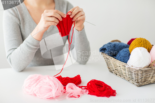 Image of woman hands knitting with needles and yarn