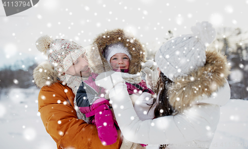 Image of happy family with child in winter clothes outdoors