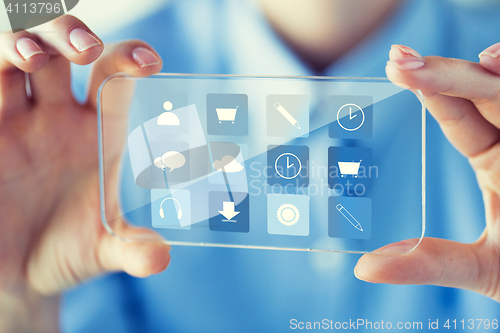 Image of close up of woman with transparent smartphone