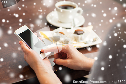 Image of woman with smartphone, coffee and dessert