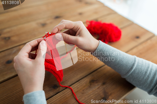 Image of woman hands knitting with needles and yarn