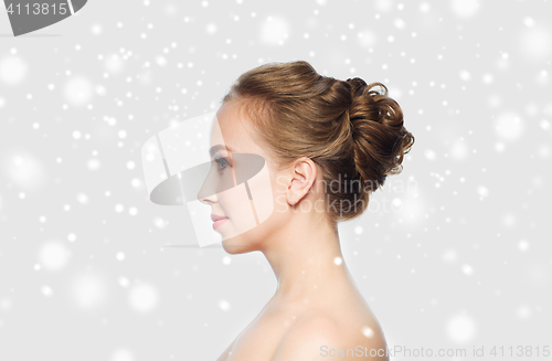 Image of beautiful young woman face over snow