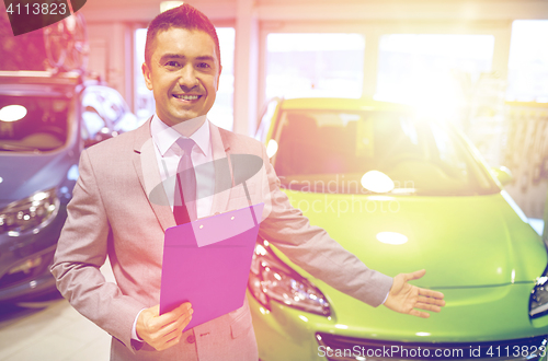 Image of happy man at auto show or car salon