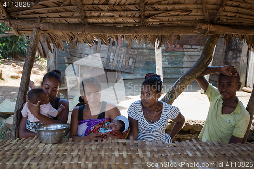 Image of Malagasy woman with baby resting under shelter