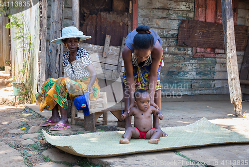 Image of Malagasy woman with baby resting in shadow, Madagascar