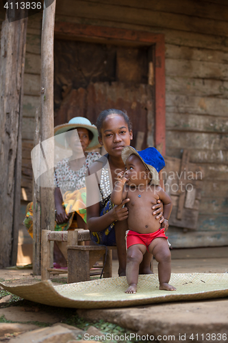 Image of Malagasy woman with baby resting in shadow, Madagascar