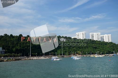 Image of Pattaya bay with commerical boats and the Pattaya City sign