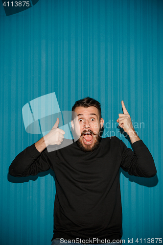 Image of Portrait of young man with shocked facial expression