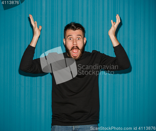 Image of Portrait of young man with shocked facial expression