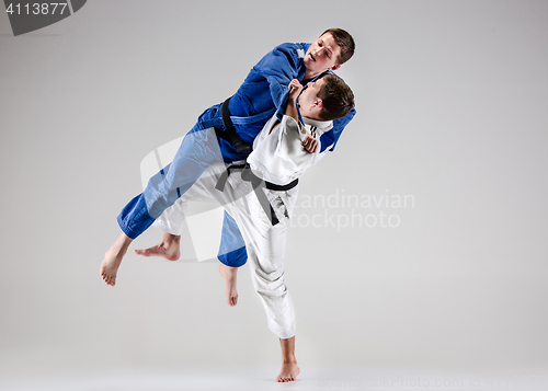 Image of The two judokas fighters fighting men