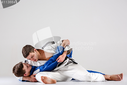 Image of The two judokas fighters fighting men