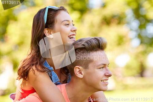 Image of happy teenage couple having fun at summer park