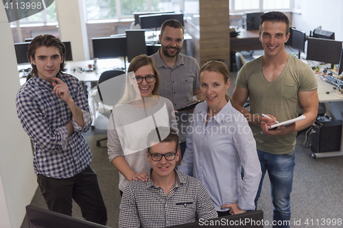 Image of group of young startup business people standing as team