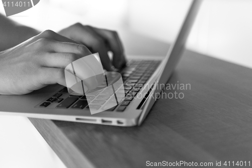 Image of close up of male hands while working in modern office