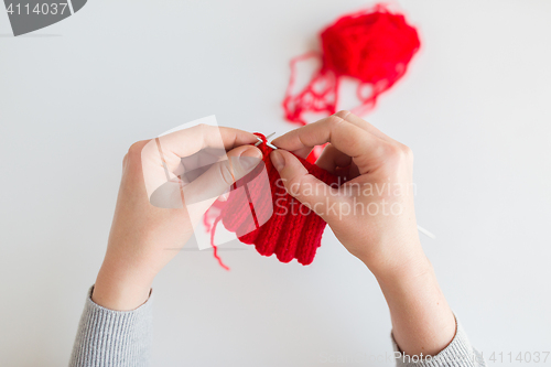 Image of woman hands knitting with needles and yarn