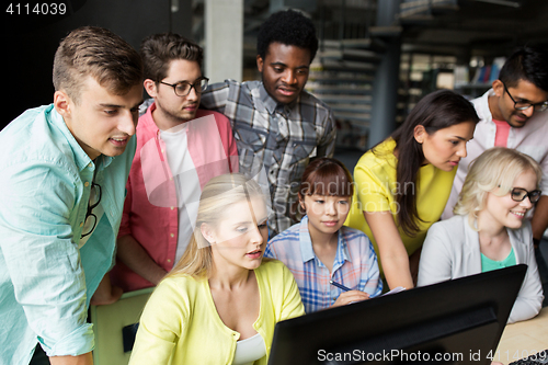 Image of international students with computers at library