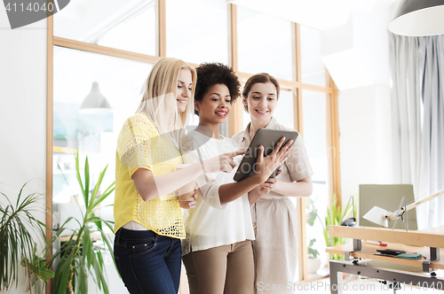 Image of happy creative team with tablet pc in office