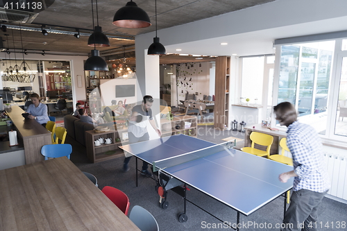 Image of playing ping pong tennis at creative office space