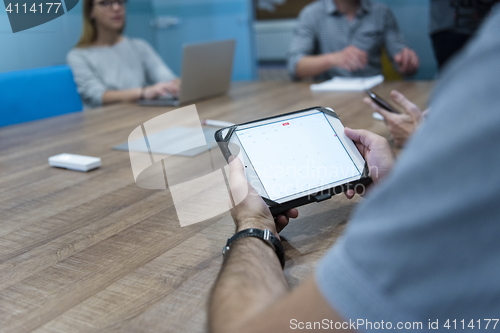 Image of close up of businessman on meeting using tablet