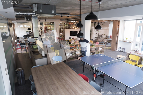 Image of playing ping pong tennis at creative office space