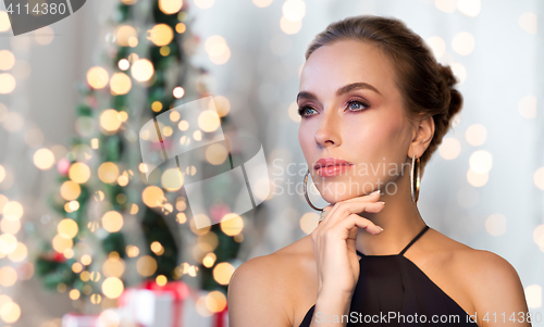 Image of beautiful woman in black wearing diamond jewelry