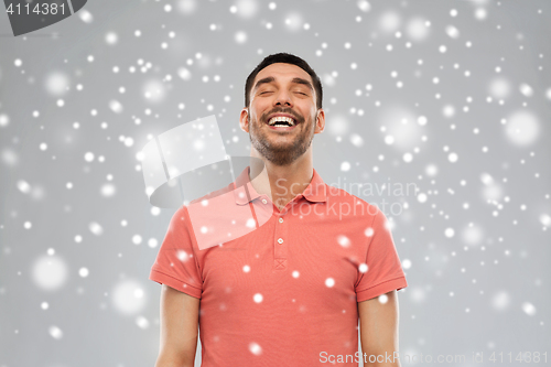 Image of happy laughing man over snow background