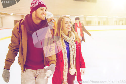 Image of happy friends on skating rink