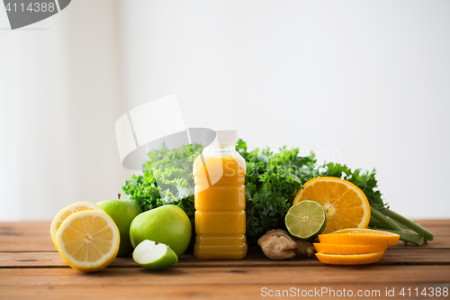 Image of bottle with orange juice, fruits and vegetables