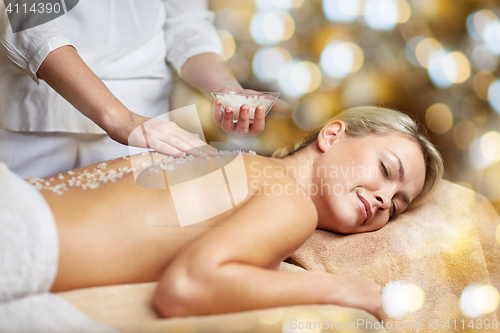 Image of close up of woman lying and having massage in spa