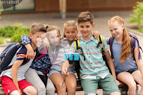 Image of happy elementary school students taking selfie