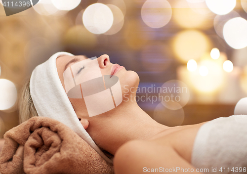 Image of close up of young woman lying in spa