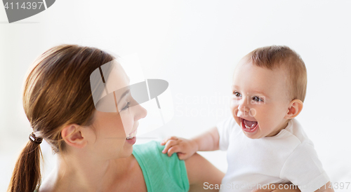 Image of happy young mother with little baby at home